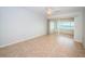 Bright bedroom featuring tile floors, a ceiling fan, and access to an outdoor patio with a water view at 100 Bluff View Dr # 405C, Belleair Bluffs, FL 33770