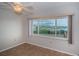Bedroom featuring a large window with scenic views and neutral finishes throughout at 100 Bluff View Dr # 405C, Belleair Bluffs, FL 33770
