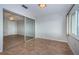Bedroom with tiled floor features a large window with a view, along with mirrored closet doors at 100 Bluff View Dr # 405C, Belleair Bluffs, FL 33770