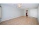 Large bedroom with neutral paint, tile flooring, a ceiling fan, and an ensuite bathroom at 100 Bluff View Dr # 405C, Belleair Bluffs, FL 33770
