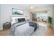 Comfortable bedroom featuring a large bed, calming decor, and sliding glass doors to a bright bonus room at 100 Bluff View Dr # 405C, Belleair Bluffs, FL 33770