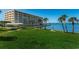 Spacious community grounds with lush lawn, tropical trees, and waterfront access at 100 Bluff View Dr # 405C, Belleair Bluffs, FL 33770