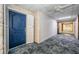 View of a well-maintained hallway with patterned carpet and a blue unit door at 100 Bluff View Dr # 405C, Belleair Bluffs, FL 33770