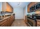 Neutral kitchen features stainless steel appliances, granite counters, and wood cabinets at 100 Bluff View Dr # 405C, Belleair Bluffs, FL 33770