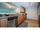 Kitchen featuring granite countertops, stainless steel dishwasher, and wooden cabinetry at 100 Bluff View Dr # 405C, Belleair Bluffs, FL 33770