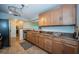 Well-lit kitchen boasts granite countertops, stainless steel appliances, and wooden cabinets at 100 Bluff View Dr # 405C, Belleair Bluffs, FL 33770