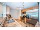 Galley kitchen with stainless steel appliances, granite countertops, and tiled floors at 100 Bluff View Dr # 405C, Belleair Bluffs, FL 33770