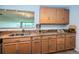 Kitchen with granite countertops, stainless steel appliances, and natural wood cabinets at 100 Bluff View Dr # 405C, Belleair Bluffs, FL 33770
