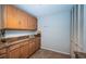 Bright kitchen with tan countertops, a white pantry, and wooden cabinets at 100 Bluff View Dr # 405C, Belleair Bluffs, FL 33770