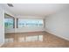 Bright living room featuring tile floors and expansive windows offering partial water views at 100 Bluff View Dr # 405C, Belleair Bluffs, FL 33770