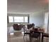 Open-concept living room featuring tile flooring, neutral paint, and view of outside at 100 Bluff View Dr # 405C, Belleair Bluffs, FL 33770