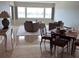 Beautifully staged living and dining area featuring tile floors, lots of natural light, and neutral walls at 100 Bluff View Dr # 405C, Belleair Bluffs, FL 33770