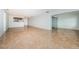 Open living space with tile flooring, kitchen area, and glass slider doors at 100 Bluff View Dr # 405C, Belleair Bluffs, FL 33770
