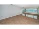 Open concept living room featuring glossy tile floors, natural light and water view at 100 Bluff View Dr # 405C, Belleair Bluffs, FL 33770