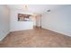 Open living room featuring tile flooring, neutral walls and a pass through to the kitchen area at 100 Bluff View Dr # 405C, Belleair Bluffs, FL 33770