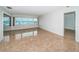 Bright living room featuring tile flooring and a large window with beautiful water views at 100 Bluff View Dr # 405C, Belleair Bluffs, FL 33770