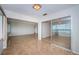Expansive living space with tile flooring, a large window, and mirrored closet doors at 100 Bluff View Dr # 405C, Belleair Bluffs, FL 33770