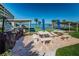 Community patio with picnic tables, grills, and shuffleboard at 100 Bluff View Dr # 405C, Belleair Bluffs, FL 33770