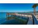 Picturesque wooden pier stretching out into the clear blue waters, perfect for leisurely strolls at 100 Bluff View Dr # 405C, Belleair Bluffs, FL 33770