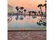 Tranquil pool scene at sunset, reflecting the beautiful sky at 100 Bluff View Dr # 405C, Belleair Bluffs, FL 33770