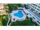 An aerial view of a community pool with lounge chairs and well-kept landscaping at 100 Bluff View Dr # 405C, Belleair Bluffs, FL 33770