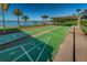 Community shuffleboard courts near the waterfront, surrounded by palm trees, offering a recreational amenity at 100 Bluff View Dr # 405C, Belleair Bluffs, FL 33770