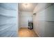 A utility room with shelving units and a hot water tank at 100 Bluff View Dr # 405C, Belleair Bluffs, FL 33770