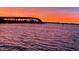 Scenic water view with a silhouetted bridge against a vibrant sunset sky at 100 Bluff View Dr # 405C, Belleair Bluffs, FL 33770
