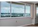 Stunning waterfront view from a bright, sunlit window in a neutral-toned room at 100 Bluff View Dr # 405C, Belleair Bluffs, FL 33770
