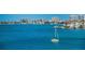 Picturesque waterfront view showcasing a sailboat on the water with buildings and homes in the background at 100 Bluff View Dr # 405C, Belleair Bluffs, FL 33770