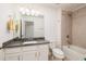 Bathroom with granite vanity, tile floors, and combined tub and shower at 17860 Althea Blue Pl, Lutz, FL 33558