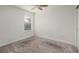 Clean, carpeted bedroom with a single window and neutral walls at 17860 Althea Blue Pl, Lutz, FL 33558