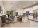 Bright kitchen with white cabinets, granite countertops, and stainless steel appliances, open to the dining area at 17860 Althea Blue Pl, Lutz, FL 33558