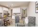 Eat-in kitchen with white cabinets, granite counters, and stainless steel appliances, next to the entry door at 17860 Althea Blue Pl, Lutz, FL 33558