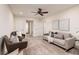 Inviting living room featuring a soft gray sofa, stylish armchairs, and contemporary decor at 17860 Althea Blue Pl, Lutz, FL 33558