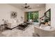 Comfortable living room with neutral decor, ceiling fan, and sliding glass doors to the outdoor area at 17860 Althea Blue Pl, Lutz, FL 33558