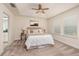 Serene main bedroom with tray ceiling, ceiling fan, and natural light at 17860 Althea Blue Pl, Lutz, FL 33558