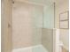 Modern walk-in shower with sleek tile and glass enclosure at 17860 Althea Blue Pl, Lutz, FL 33558