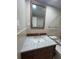Bathroom vanity with a granite countertop and wooden cabinets at 1840 Shore S Dr # 5, South Pasadena, FL 33707