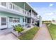 Light teal building exterior with walkway, landscaping, and a staircase at 1840 Shore S Dr # 5, South Pasadena, FL 33707