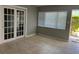 Bright living room with tiled floors and French doors leading outside at 1840 Shore S Dr # 5, South Pasadena, FL 33707