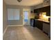 Kitchen with dark cabinets, stainless steel appliances and door to patio at 1840 Shore S Dr # 5, South Pasadena, FL 33707