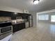 Modern kitchen with dark cabinets and stainless steel appliances at 1840 Shore S Dr # 5, South Pasadena, FL 33707