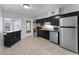 Modern kitchen with dark cabinets, stainless steel appliances and kitchen island at 1840 Shore S Dr # 5, South Pasadena, FL 33707