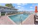 Community pool with brick patio and lounge chairs at 1840 Shore S Dr # 5, South Pasadena, FL 33707