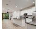 Open kitchen with island, stainless steel appliances, and white cabinets at 17860 Althea Blue Pl, Lutz, FL 33558