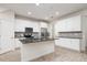 Modern kitchen with white cabinets, granite countertops and island at 17860 Althea Blue Pl, Lutz, FL 33558