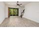 Living room with sliding glass doors and wood-look tile floor at 17860 Althea Blue Pl, Lutz, FL 33558