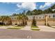 Exterior view of townhouses with garages and landscaping at 17860 Althea Blue Pl, Lutz, FL 33558