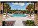 Resort-style pool with fountain and palm trees at 17860 Althea Blue Pl, Lutz, FL 33558